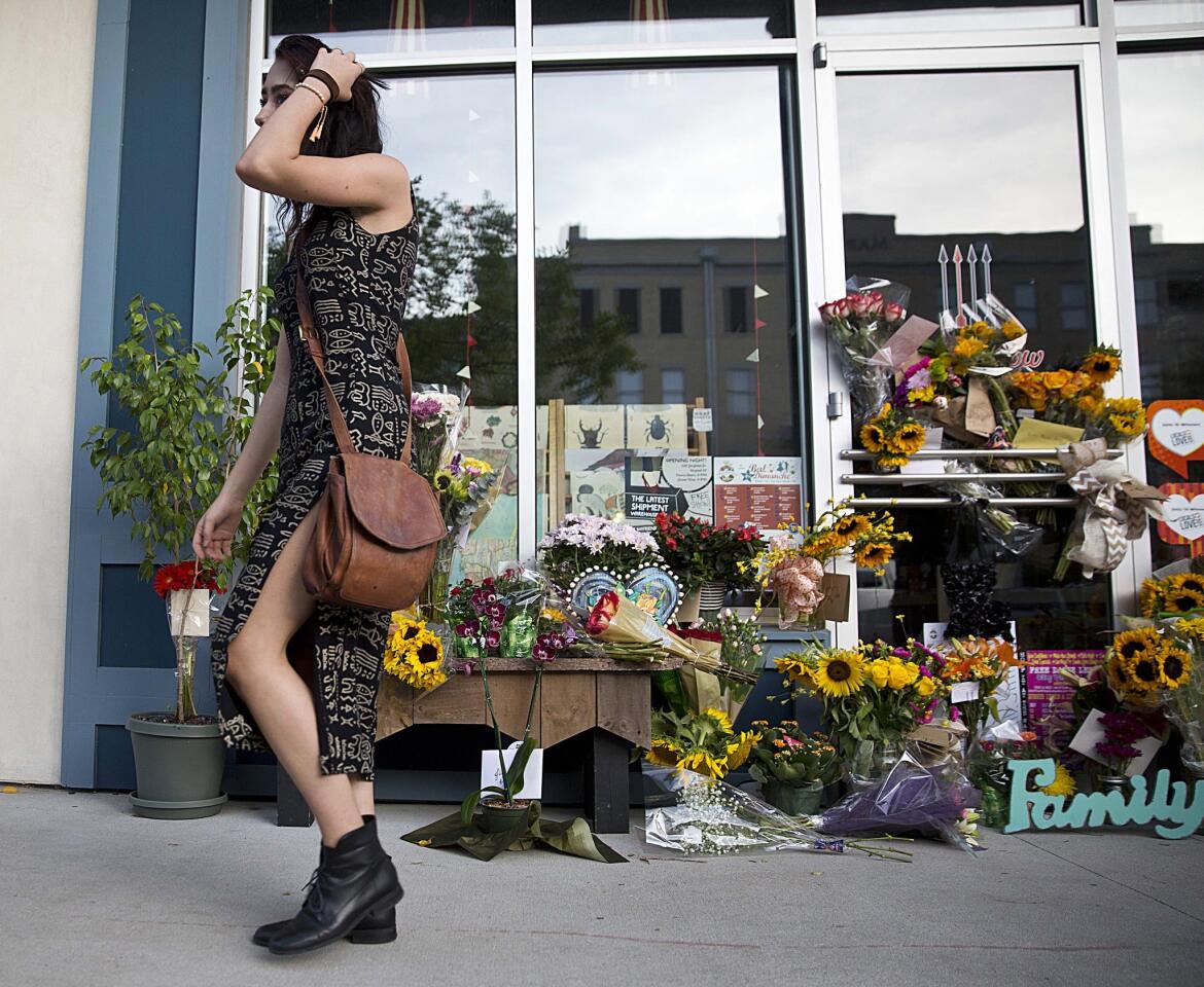 Mourners leave flowers in front of the Red Arrow Workshop, a boutique owned by Lafayatte, La. shooting victim Jillian Johnson and her husband on July 24, 2015.