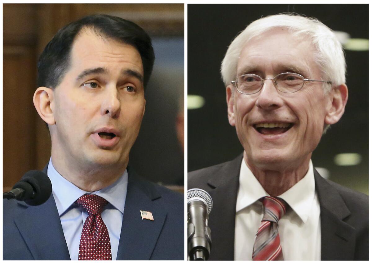 Wisconsin Gov. Scott Walker, left, and the governor-elect, Tony Evers.