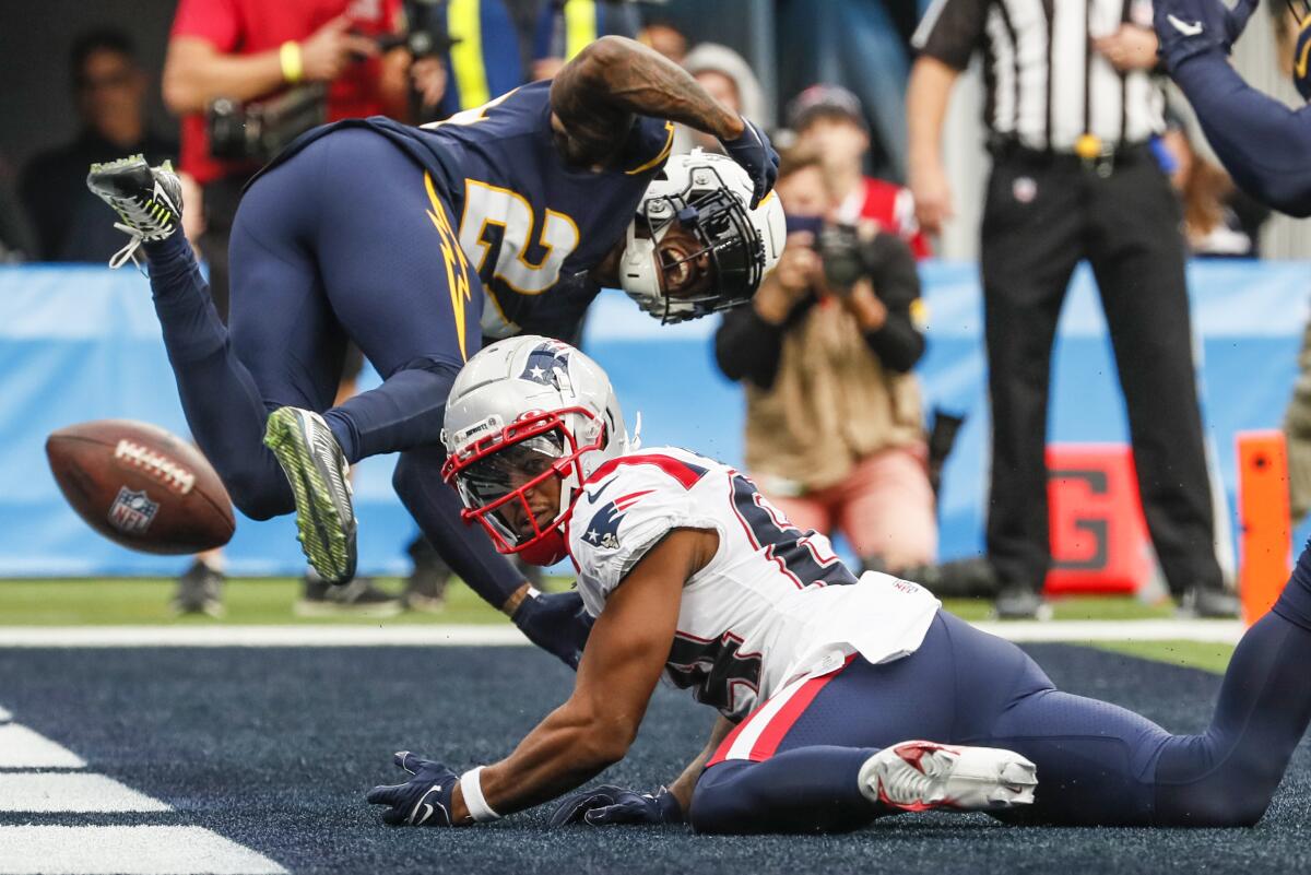 Chargers safety Nasir Adderley (24) breaks up a pass intended for New England Patriots wide receiver Kendrick Bourne.