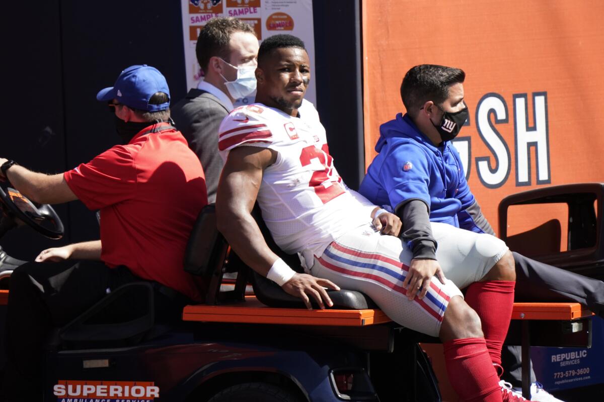 New York Giants running back Saquon Barkley is transported to the locker room after being injured.