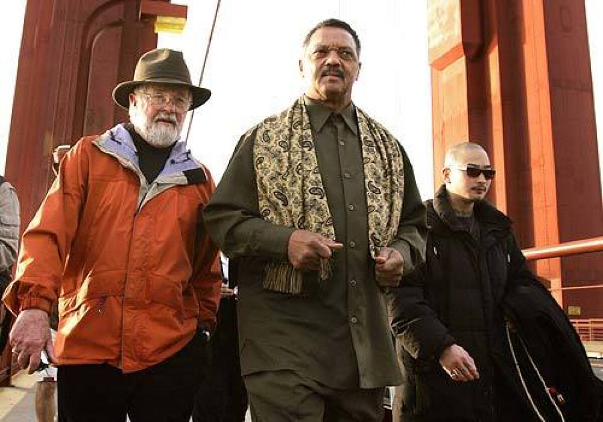 Jesse Jackson, Lyle Grosjean, left, and Hong Chingkuang lead about 30 anti-death penalty protesters across the Golden Gate Bridge early Monday. Grosjean is a retired Episcopal minister, and Chingkuang is a prison program coordinator for the Buddhist Peace Fellowship.