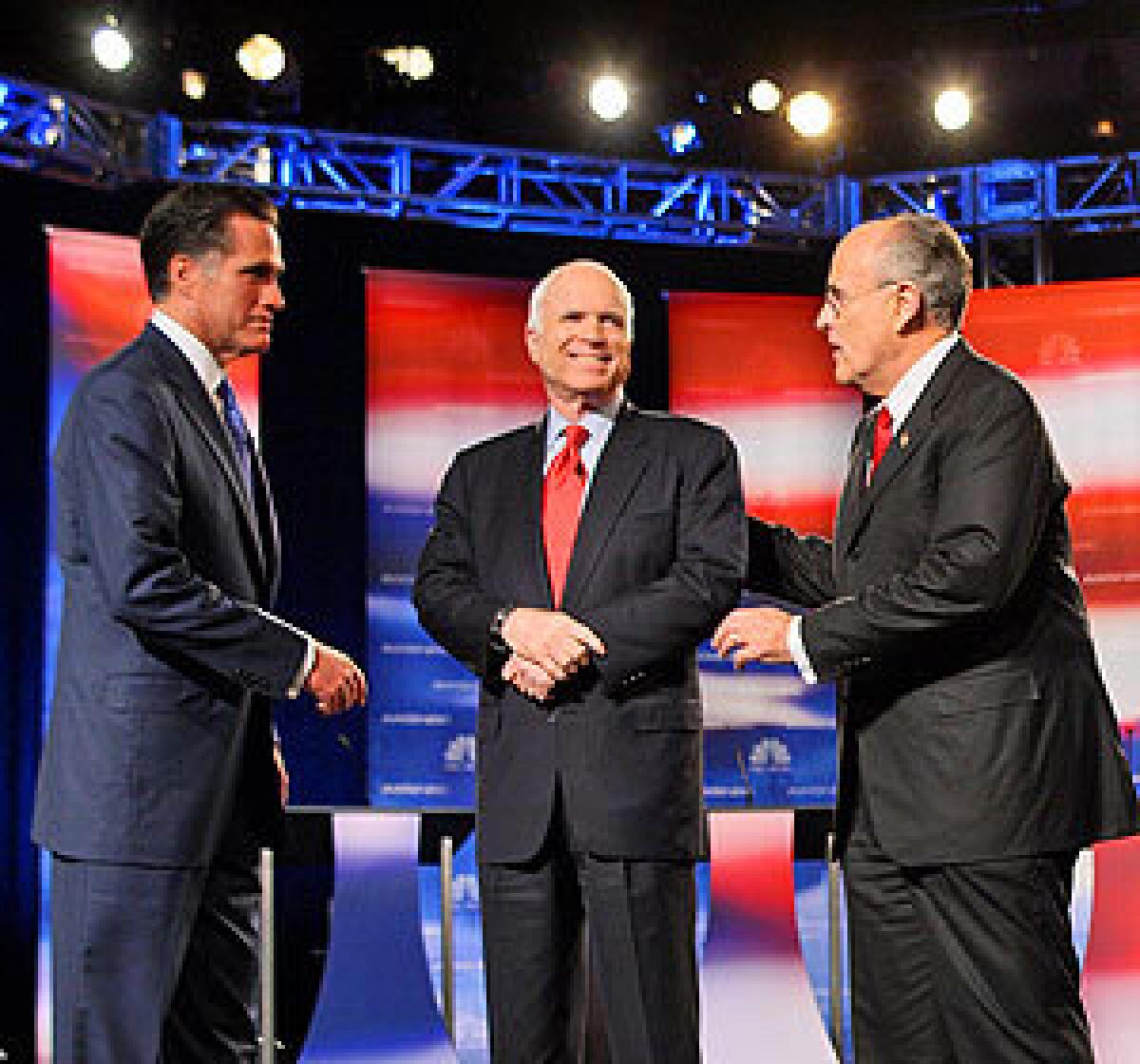 Republican presidential hopefuls Mitt Romney, John McCain and Rudy Giuliani greet each other at the start of the debate.