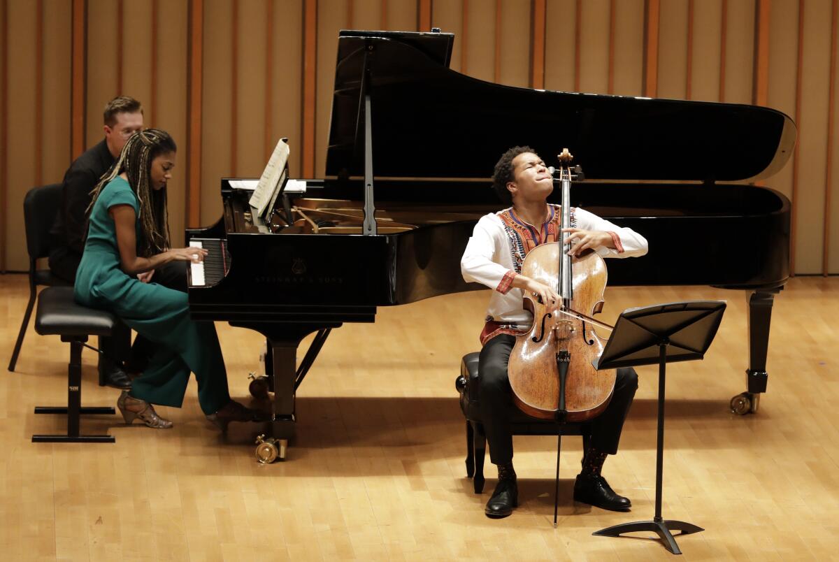 Sheku Kanneh-Mason plays cello with his sister Isata Kanneh-Mason on piano Tuesday at the Colburn School in L.A. 