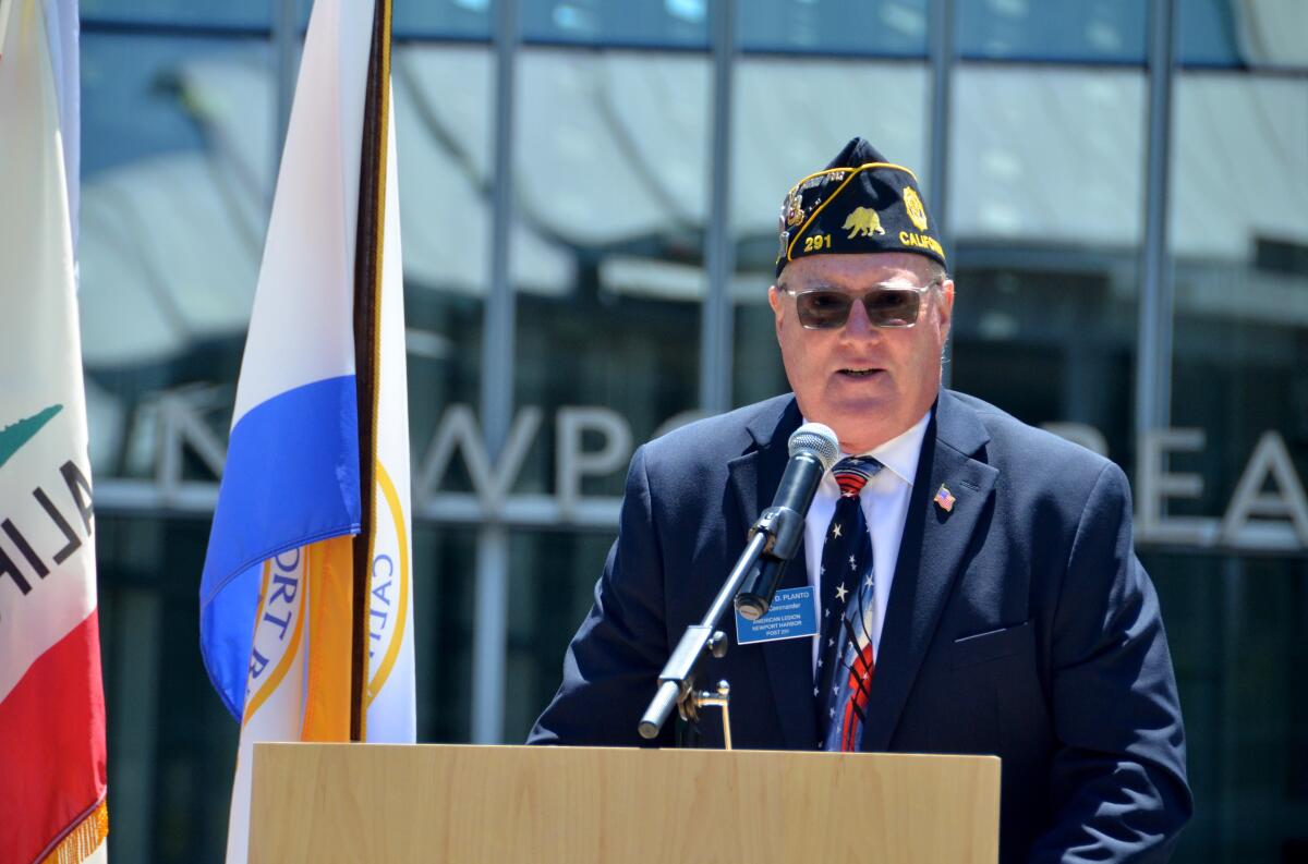 Army combat veteran Evin Planto talks about the flag Friday at Newport Beach Civic Center Flag Day event.