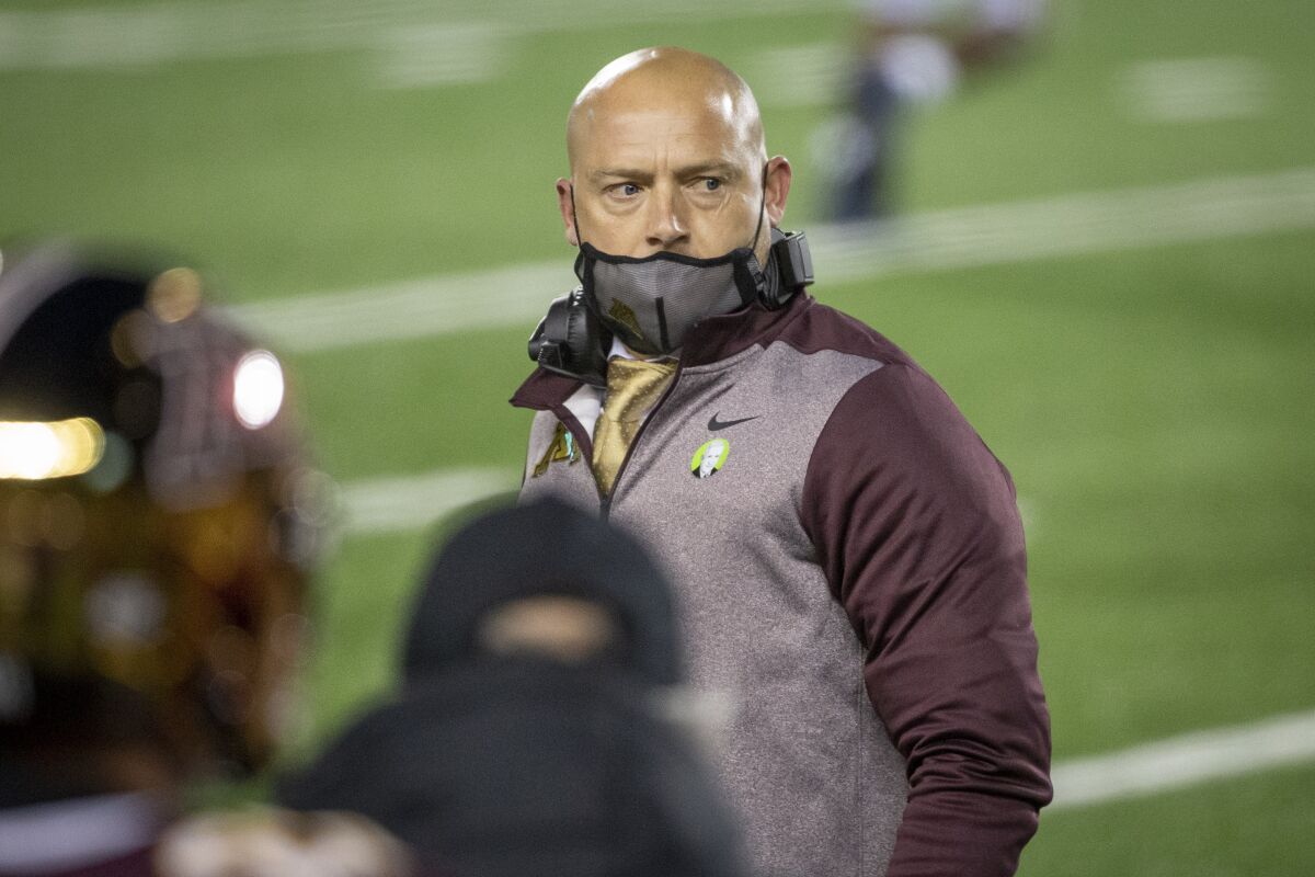 FILE - In this Oct. 24, 2020, file photo, Minnesota head coach P.J. Fleck looks at his bench during an NCAA college football game with Michigan in Minneapolis. Minnesota is among 10 of the 14 Big Ten football teams sitting at two wins entering the final weekend of the regular season. The statistical anomaly begs the question of whether it's difficult for those teams to stay motivated in a season that brought unique challenges because of the coronavirus pandemic. (AP Photo/Bruce Kluckhohn, File)