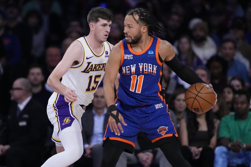 Los Angeles Lakers' Austin Reaves (15) defends New York Knicks' Jalen Brunson (11) during the first half of an NBA basketball game Saturday, Feb. 3, 2024, in New York. (AP Photo/Frank Franklin II)