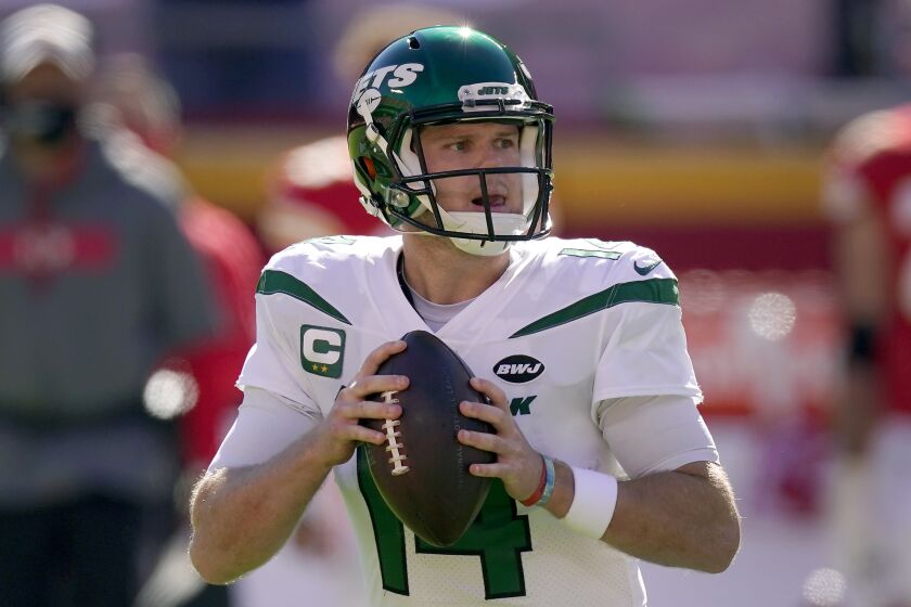 New York Jets quarterback Sam Darnold looks for a receiver during the first half of an NFL football game.