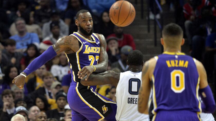 Lakers forward LeBron James whips a pass cross court to teammate Kyle Kuzma during the first half Saturday.
