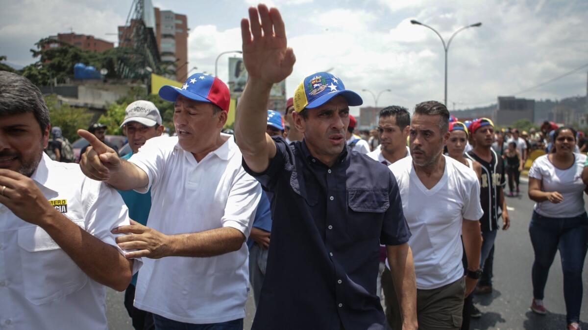 Miranda state governor and oposition leader, Henrique Capriles, leads a demonstration while hundreds of people protest in Caracas, Venezuela.