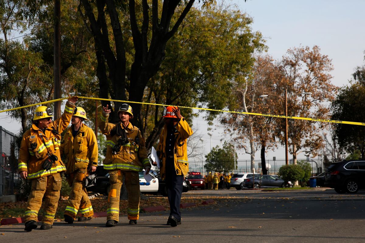 Emergency workers respond after an LAX-bound plane dumped fuel on a playground at Park Avenue Elementary School on Jan. 14 in Cudahy, Calif.