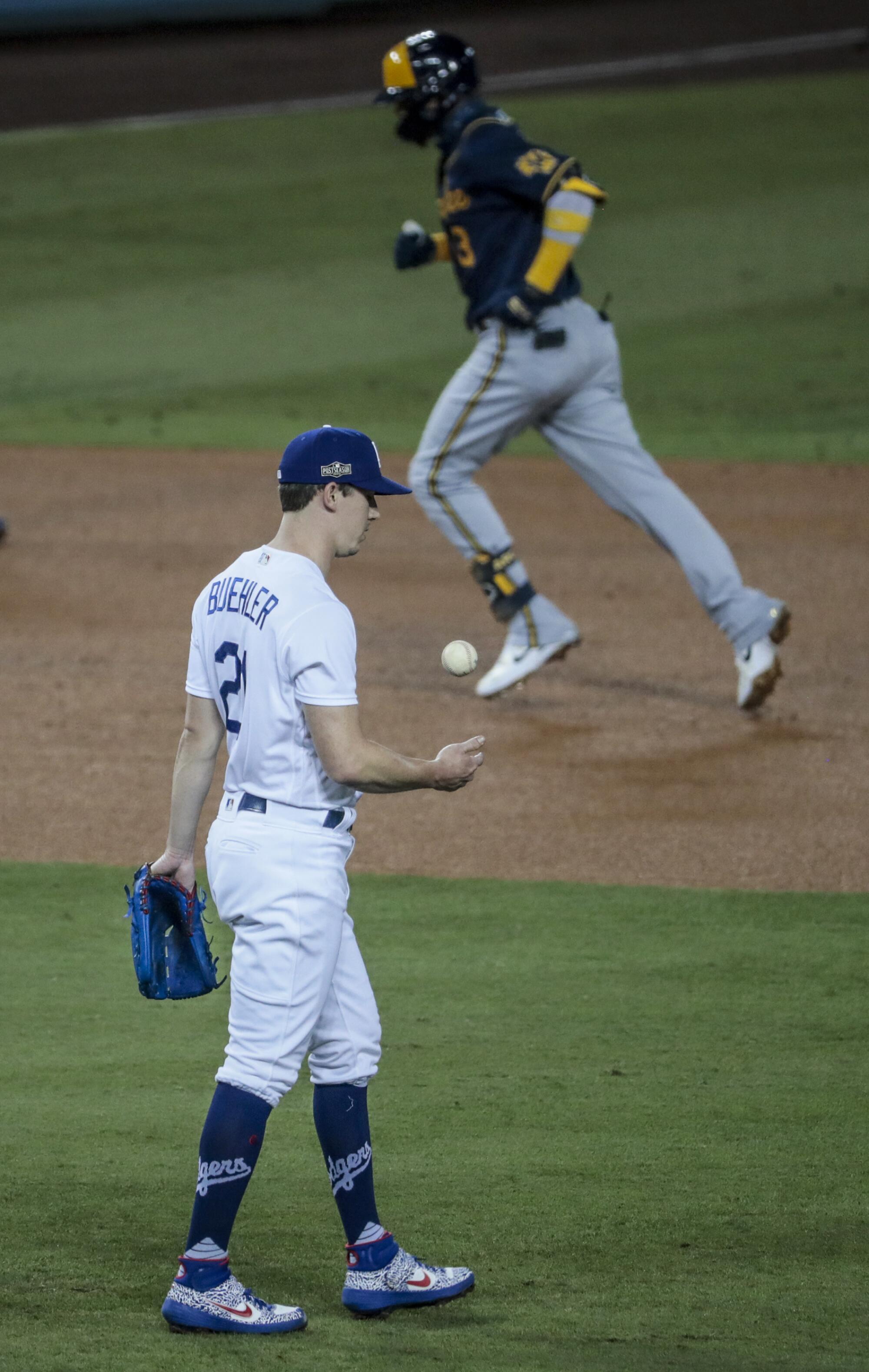Milwaukee Brewers shortstop Orlando Arcia rounds the bases after hitting a home run off Dodgers pitcher Walker Buehler.