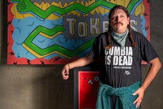 LOS ANGELES, CA - OCTOBER 5: Chef Diego Argoti next to an arcade token machine in Button Mash on Friday, October 5, 2023 in Los Angeles, CA. (Ron De Angelis / For The Times)