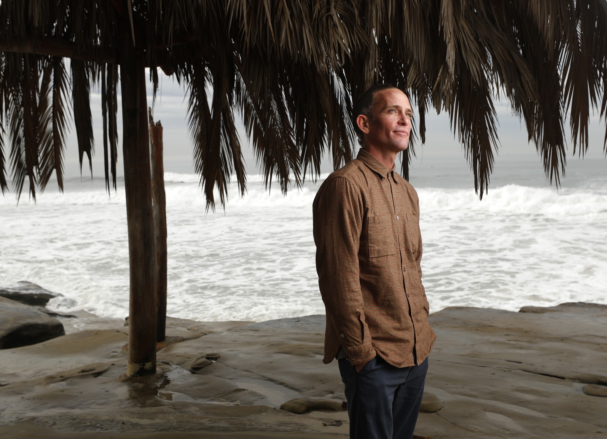 Derek Dunfee stands at the shack at Windansea Beach in La Jolla 