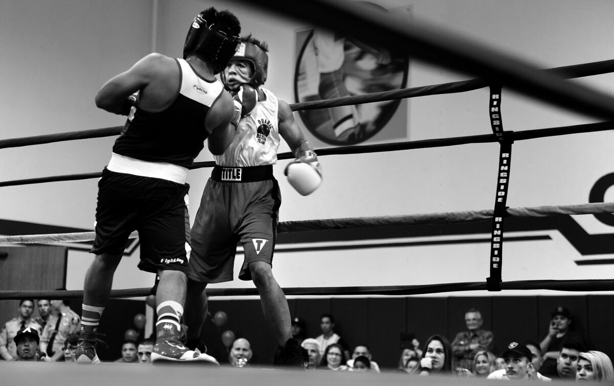 Pat takes a punch in the opening round during his first match as a male boxer at a tournament in Covina.