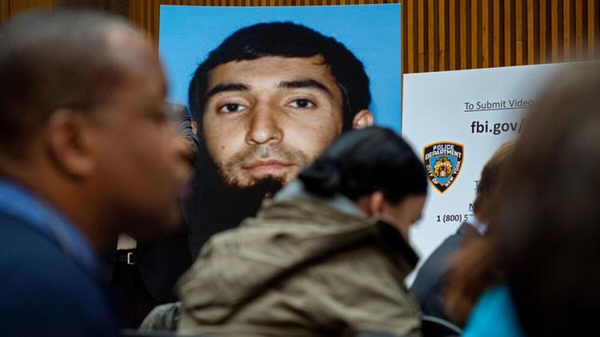 A photo of accused terrorist Sayfullo Saipov is displayed at a news conference after his arrest.