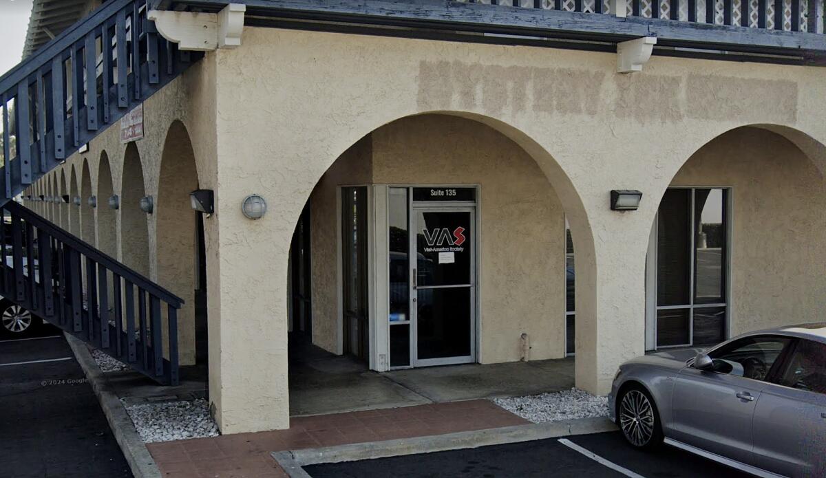 Exterior of a business building with rounded archways.