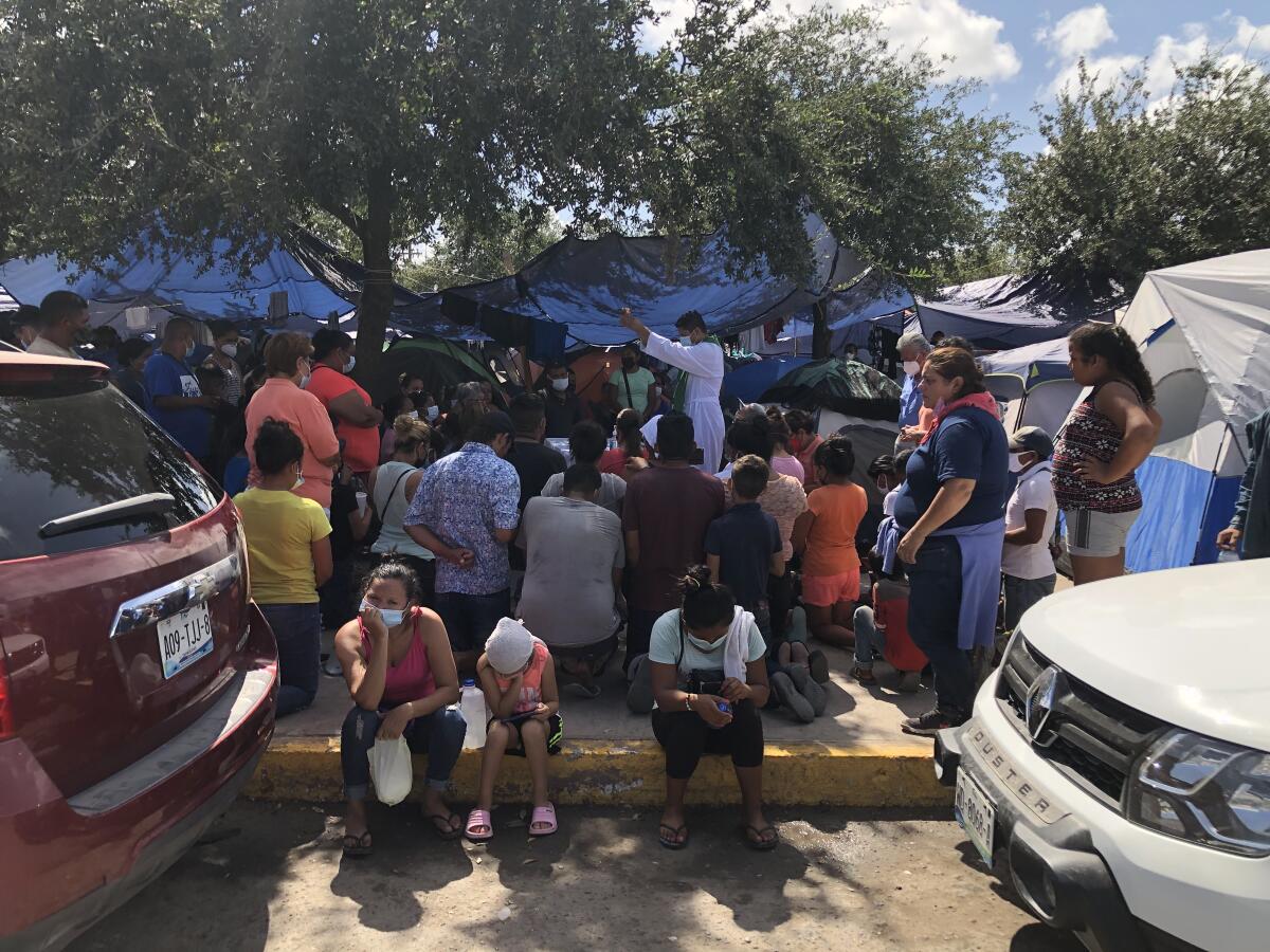 A local priest leads worship at Plaza Las Americas migrant camp in Reynosa, Mexico.