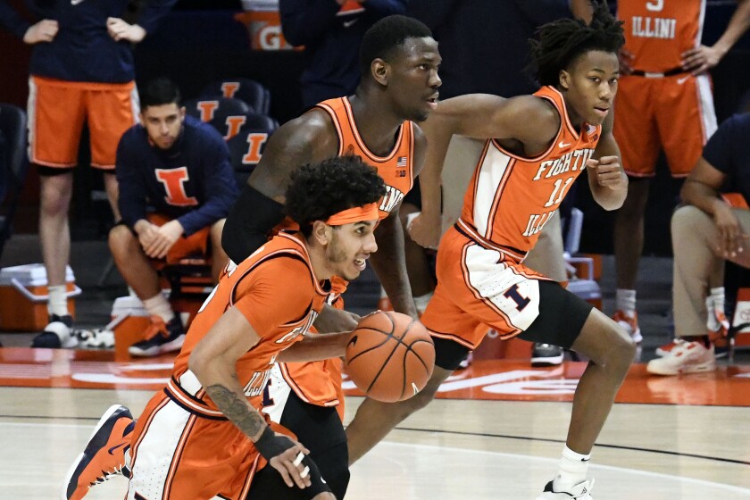 Illinois guard Andre Curbelo (5) center Kofi Cockburn (21) and guard Ayo Dosunmu (11) bring the ball down court against Northwestern in the first half of an NCAA college basketball game Tuesday, Feb. 16, 2021, in Champaign, Ill. (AP Photo/Holly Hart)