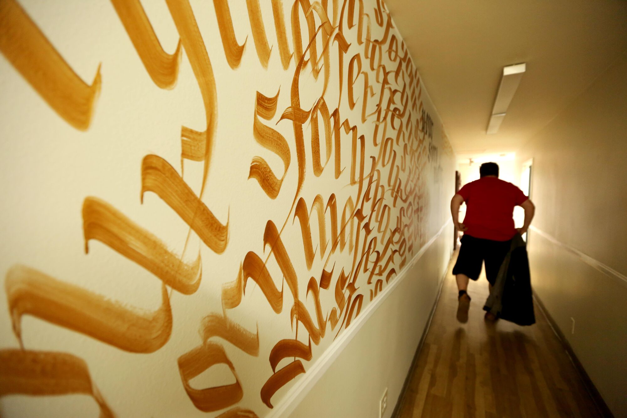 Andrew Truelove makes his way down a hallway at the Beacon Light Mission in Wilmington.