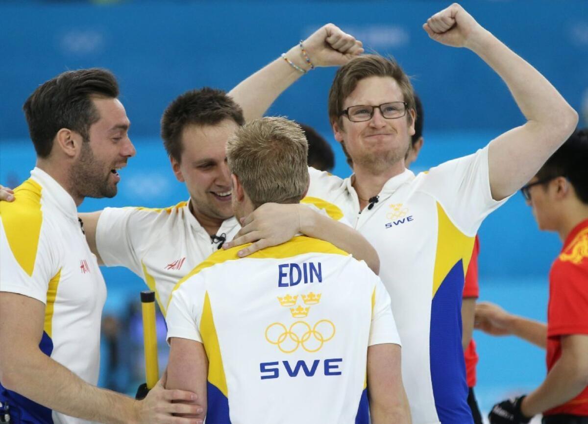 Sweden celebrates its bronze medal in men's curling.