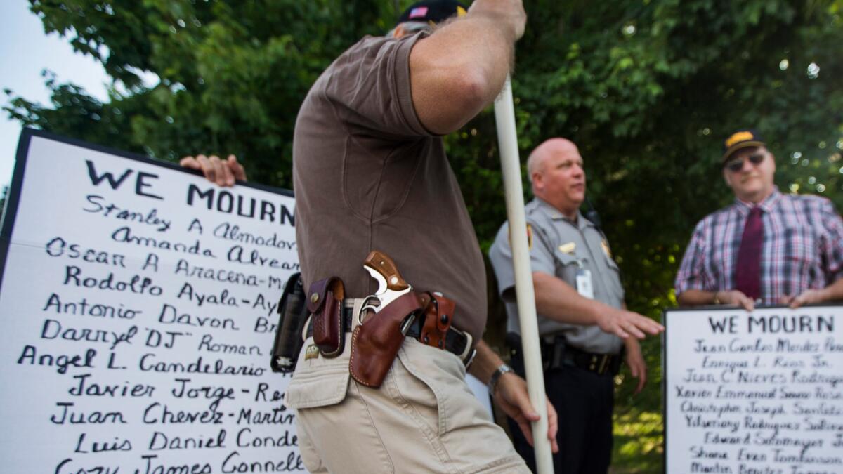 Pro-gun demonstrators rally outside the headquarters of the National Rifle Assn. in Fairfax, Va., on Tuesday.