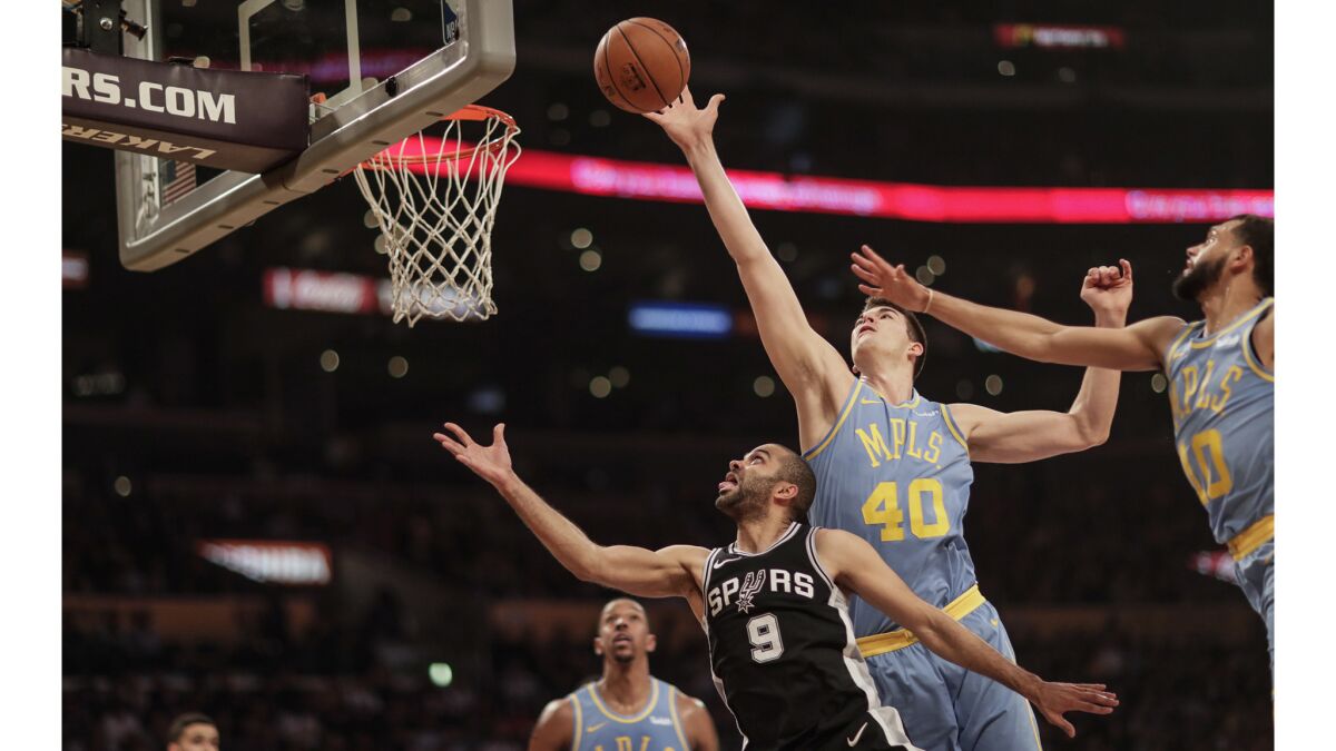 Lakers center Ivaca Zubac blocks the shot of Spurs guard Tony Parker during first-half action.