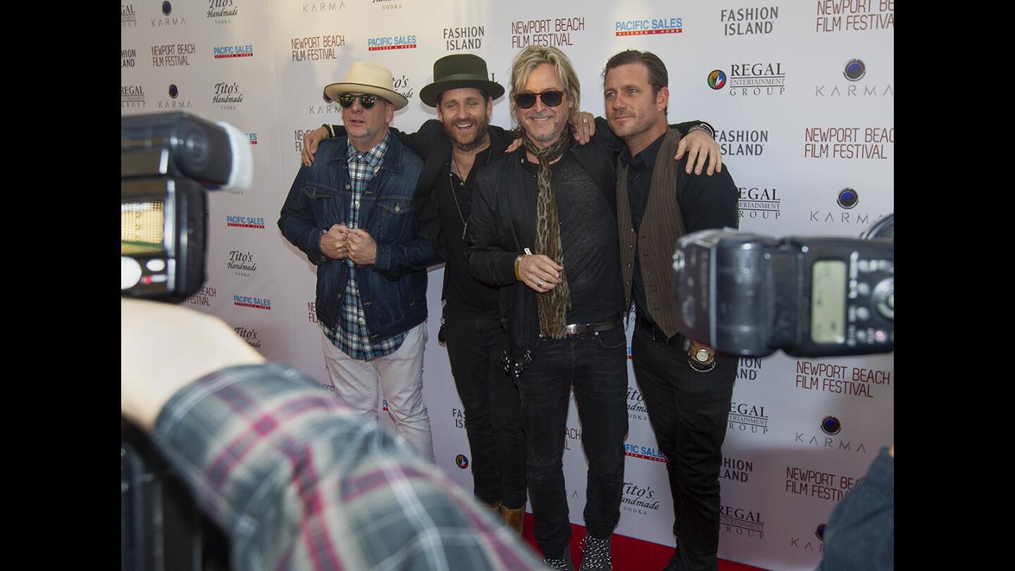 Side Deal band members, left to right, Stan Frazier, Scott Owen, Charlie Colin and Joel Owen pose for photos as they walk the red carpet during opening night for the 2018 Newport Beach Film Festival at Edwards Big Newport 6 & RPX movie theatre on Thursday, April 26.