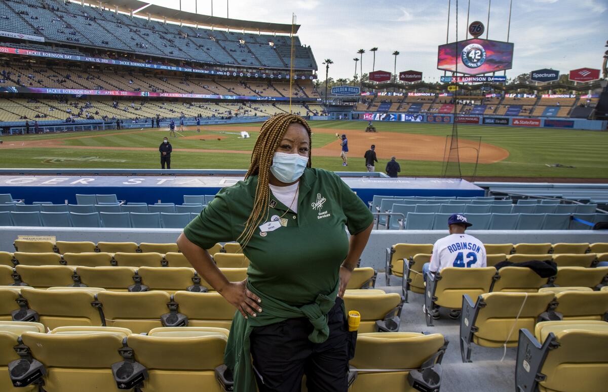 Sachi Hamilton, great-niece of the baseball legend Jackie Robinson, poses in front of the field at Dodger Stadium.