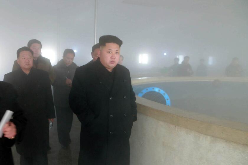 North Korean leader Kim Jong Un, right, is seen inspecting a catfish farm in Pyongyang.