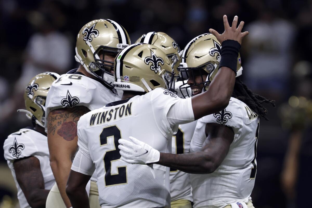 New Orleans Saints quarterback Jameis Winston (2) celebrates his touchdown pass with wide receiver Marquez Callaway (1), who caught the pass, in the first half of an NFL preseason football game against the Jacksonville Jaguars in New Orleans, Monday, Aug. 23, 2021. (AP Photo/Brett Duke)