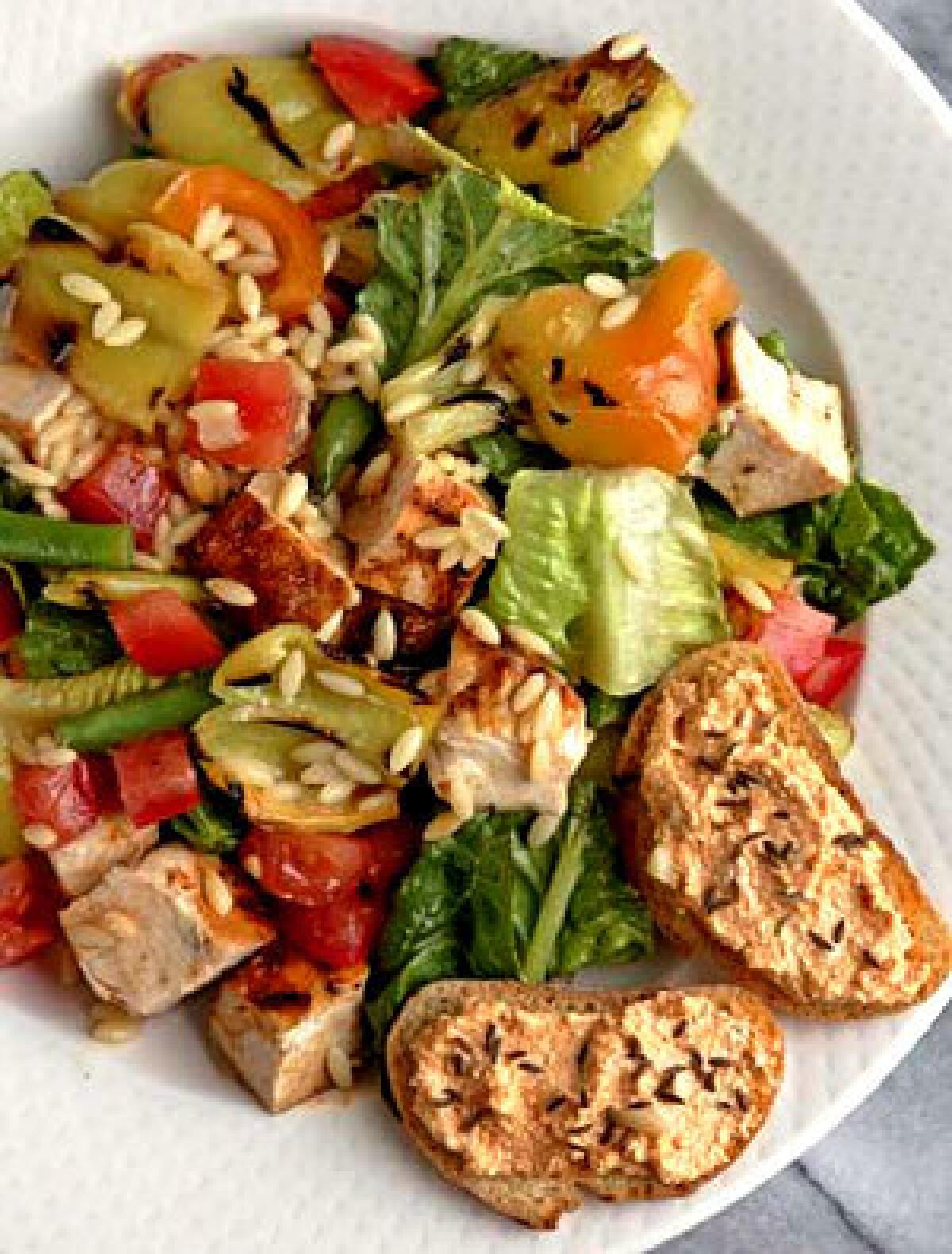 TOSSED: Grilled Hungarians gain a smoky sweetness that gives definition to chicken salad.