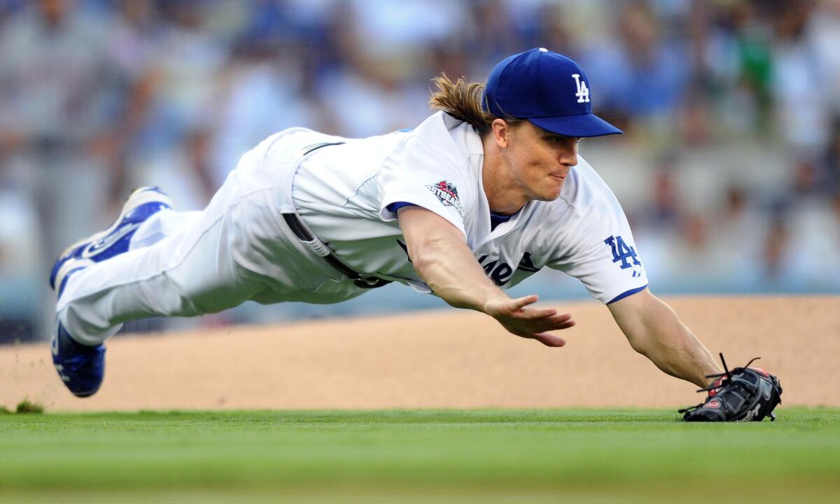 Dodgers starter Zack Greinke dives in vain for a ground ball hit by the Mets' Curtis Granderson in the first inning of Game 5 of the divisional playoffs on Oct. 15, 2015, at Dodger Stadium.