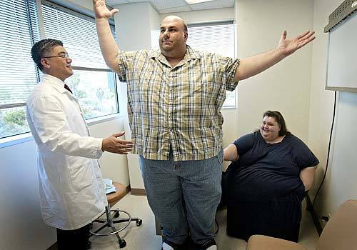 STAND-UP GUY: Cyrus Tehrani exclaims upon standing from a prone position at a pre-surgery checkup last spring by bariatric surgeon Dr. Carson Liu, left, as sister Sheila watches.
