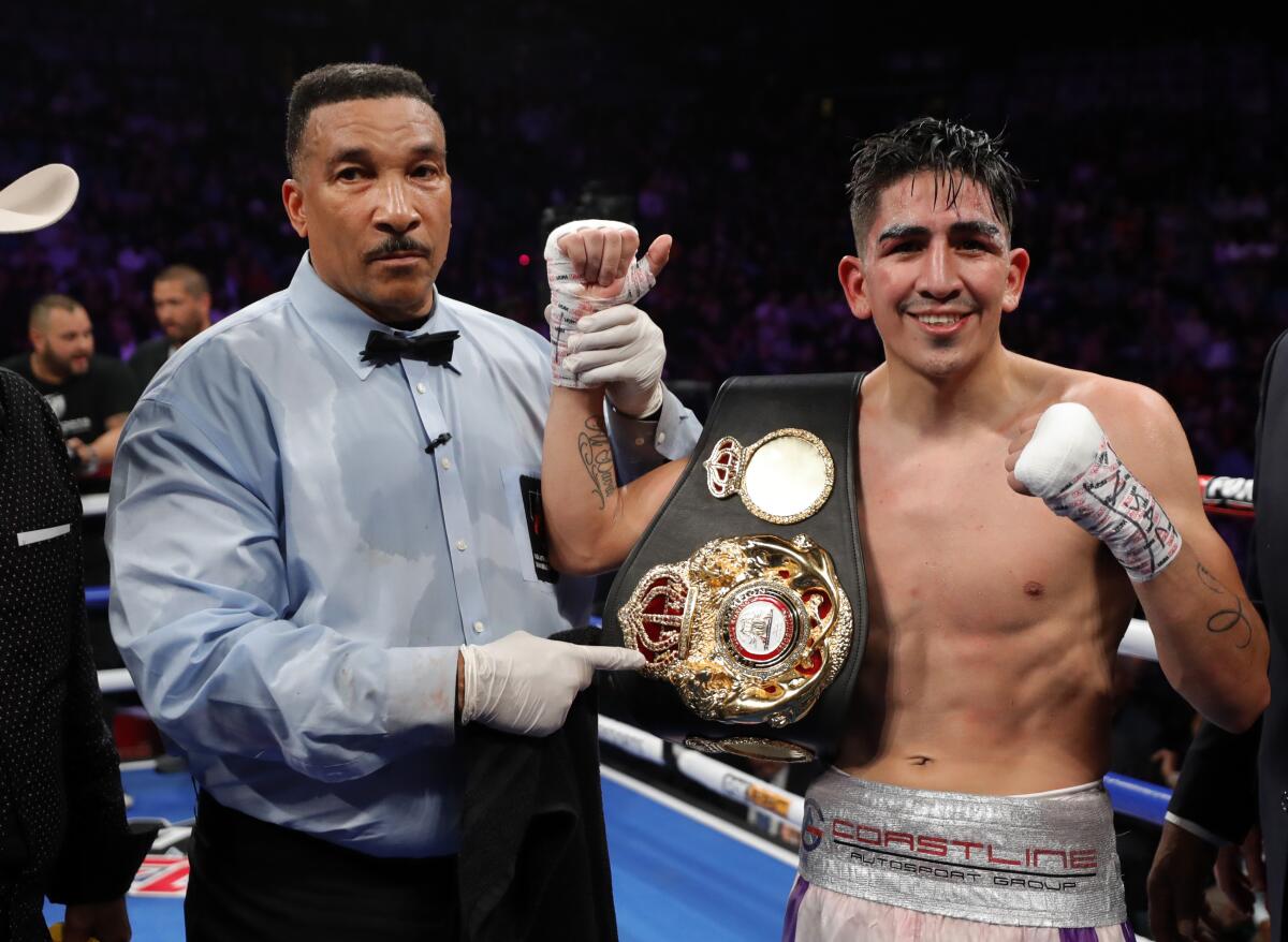 LAS VEGAS, NEVADA - NOVEMBER 23: Leo Santa Cruz poses with referee Tony Weeks after defeating Miguel Flores in a fight for the vacant WBA super featherweight title at MGM Grand Garden Arena on November 23, 2019 in Las Vegas, Nevada. (Photo by Steve Marcus/Getty Images) ** OUTS - ELSENT, FPG, CM - OUTS * NM, PH, VA if sourced by CT, LA or MoD **