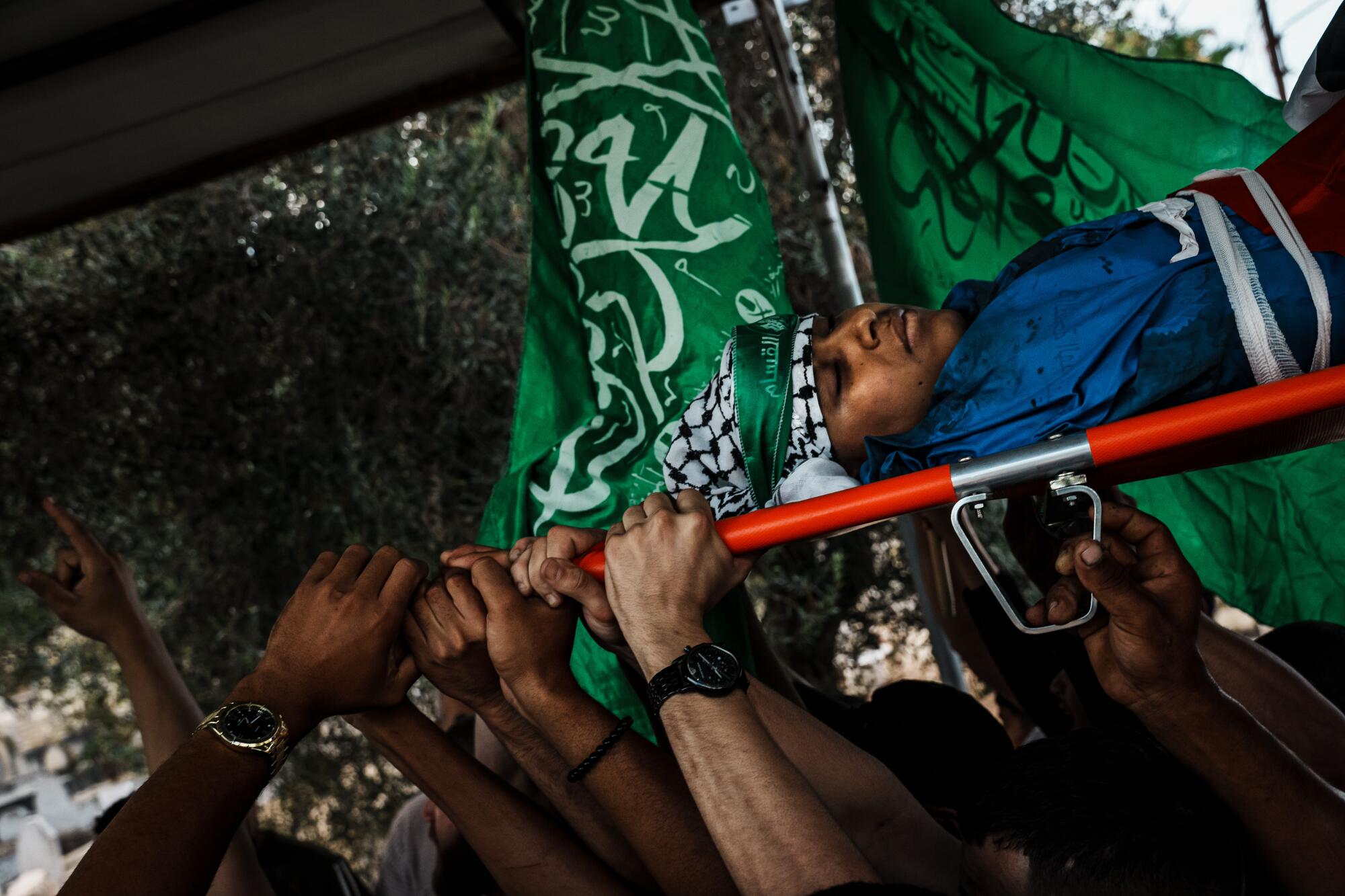 Mourners carry the body of Ali Khazneh, 15, to his burial in Tulkarem.