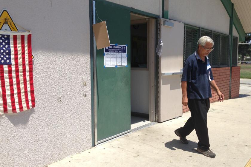 A poll worker who declined to identify himself steps out of the City of Los Angeles voting precinct at the Panorama Recreation Center.