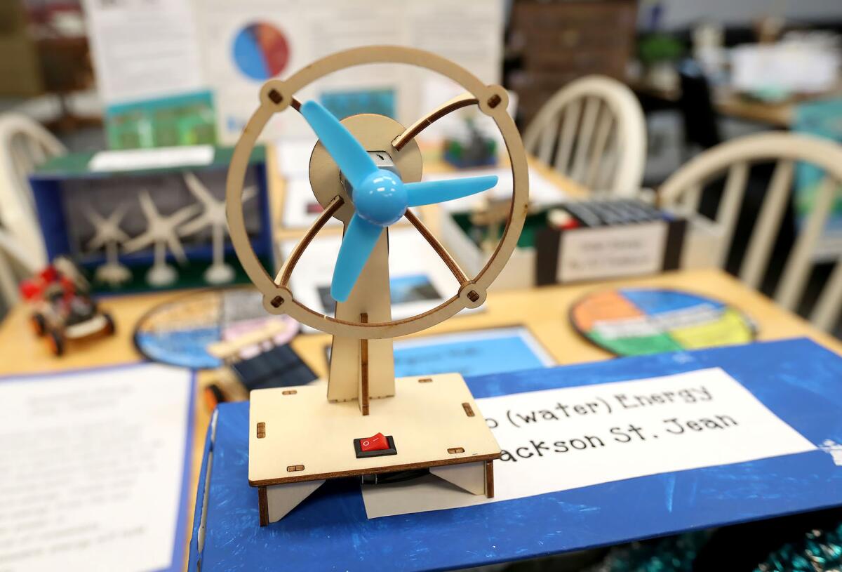 A student windmill energy system display is shown during the Environmental Science Civic Engagement Showcase.