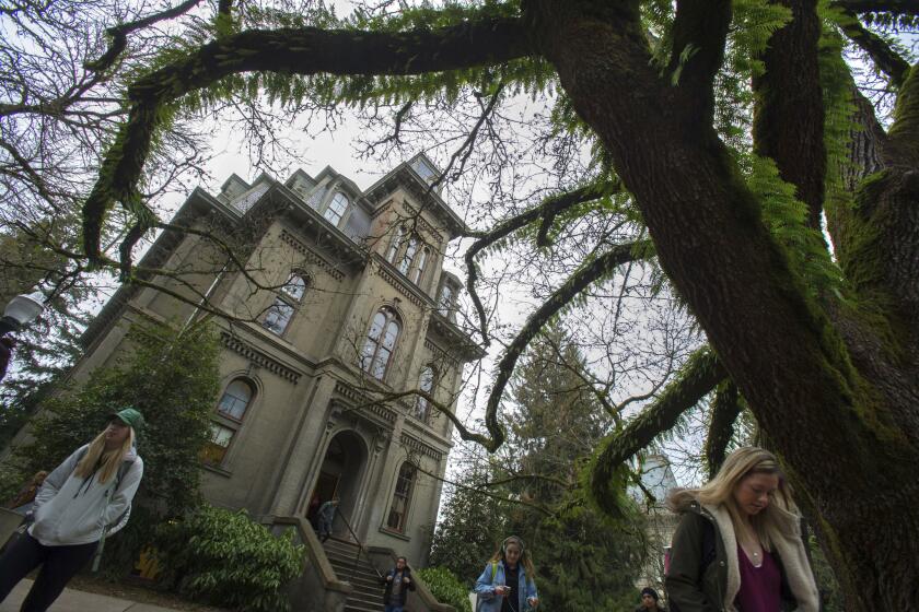 Students exit Deady Hall on the campus of the University of Oregon Wednesday, Jan. 25, 2017. The name of UO founder Matthew Deady will remain on the oldest building on campus, UO University of Oregon President Michael Schill announced Wednesday. After more than a year of study and committee work, the president ruled that Deady â who died in 1893 â was a mixed bag, and though he promoted slavery before the Civil War, he also founded a university and spoke up for Chinese immigrants. (Brian Davies/The Register-Guard via AP)