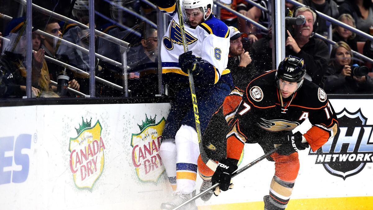Ducks center Ryan Kesler and Blues defenseman Joel Edmundson battle along the boards for possession of the puck in the third period Friday night.