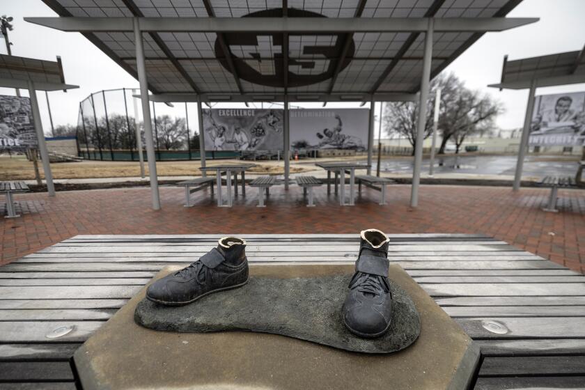 FILE - A bronze statue of legendary baseball pioneer Jackie Robinson was stolen from a park in Wichita, Kan., during the early morning hours of Thursday, Jan. 25, 2024. The bronze Jackie Robinson cleats that were left behind when a statue of the first player to break Major League Baseball’s color barrier was stolen from a Kansas park are being donated to the Negro Leagues Baseball Museum. (Travis Heying/The Wichita Eagle via AP, File)