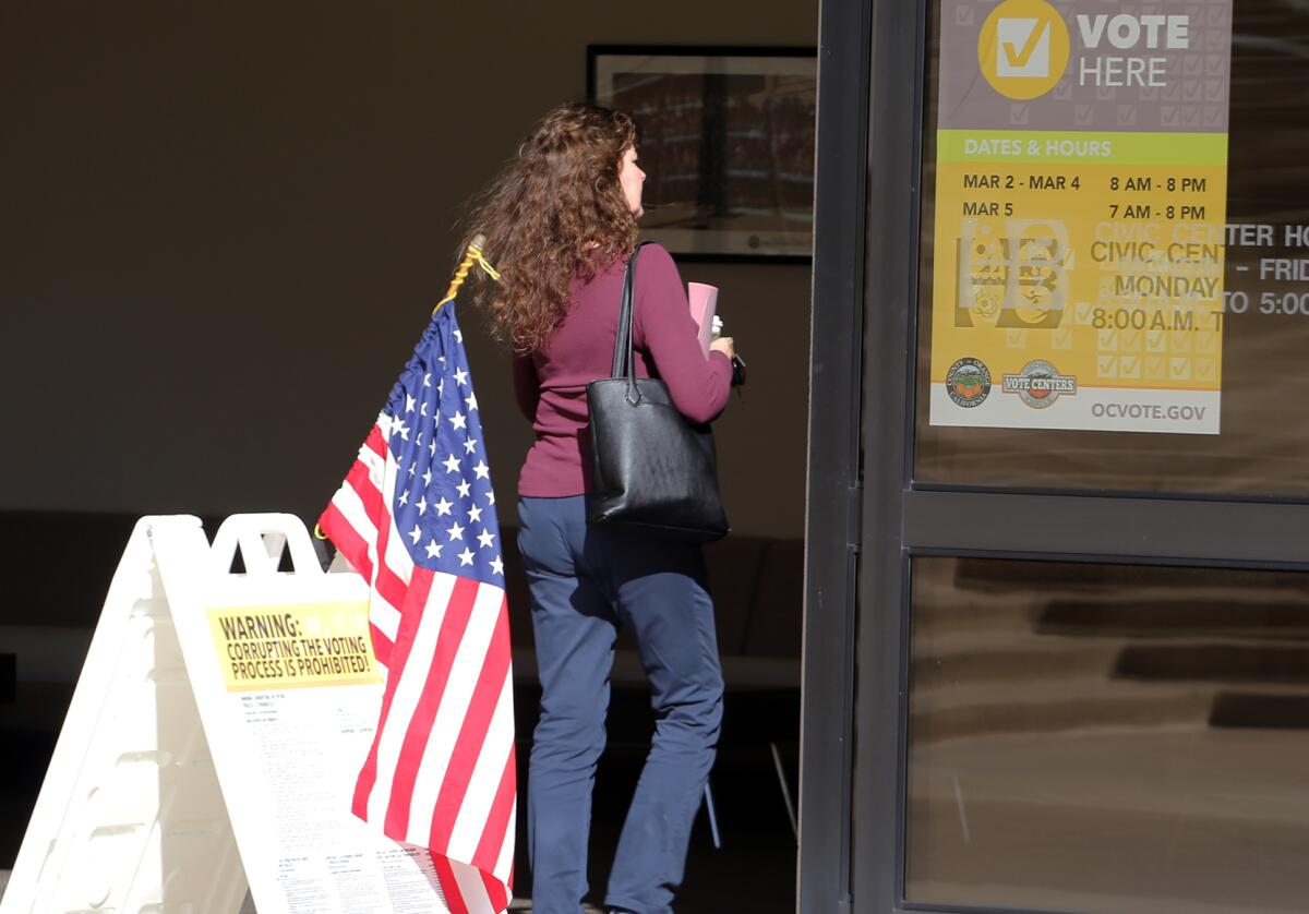 A woman walks into Huntington Beach City Hall to vote on Tuesday.