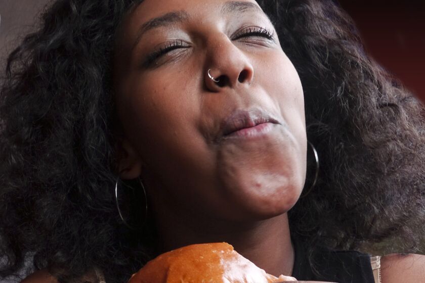 Black girl eating a sandwich
