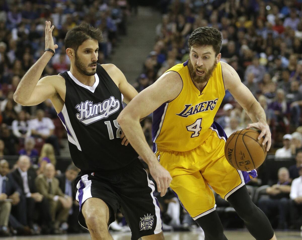 Lakers forward Ryan Kelly drives against Kings forward Omri Casspi during the first half on Monday.