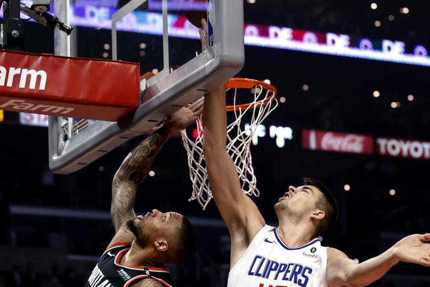 Los Angeles Clippers' Ivica Zubac, right, blocks a shot by Portland Trail Blazers' Damian Lillard during the first half of an NBA basketball game Tuesday, March 12, 2019, in Los Angeles. (AP Photo/Ringo H.W. Chiu)