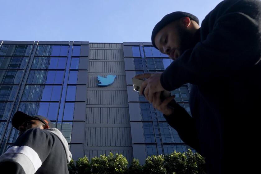 People walk outside Twitter headquarters in San Francisco, Friday, Nov. 4, 2022. Employees were bracing for widespread layoffs at Twitter on Friday, as new owner Elon Musk overhauls the social platform. (AP Photo/Jeff Chiu)