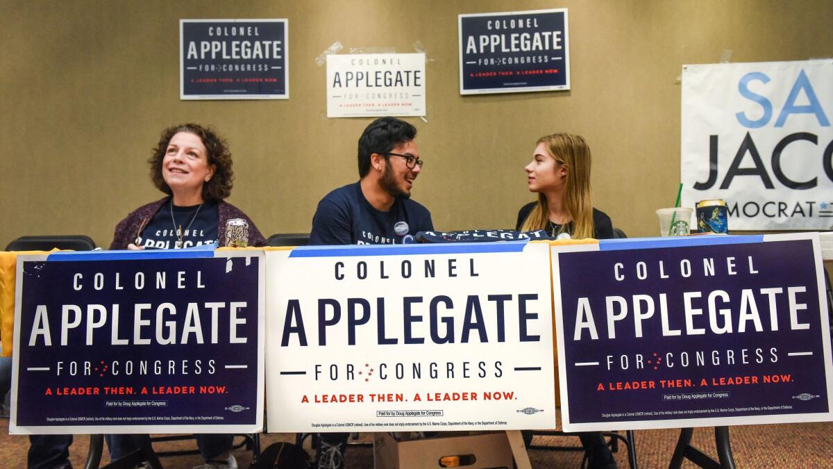 Volunteers man a table for Doug Applegate before a debate between the five Democrats running for Rep. Darrell Issa's seat.