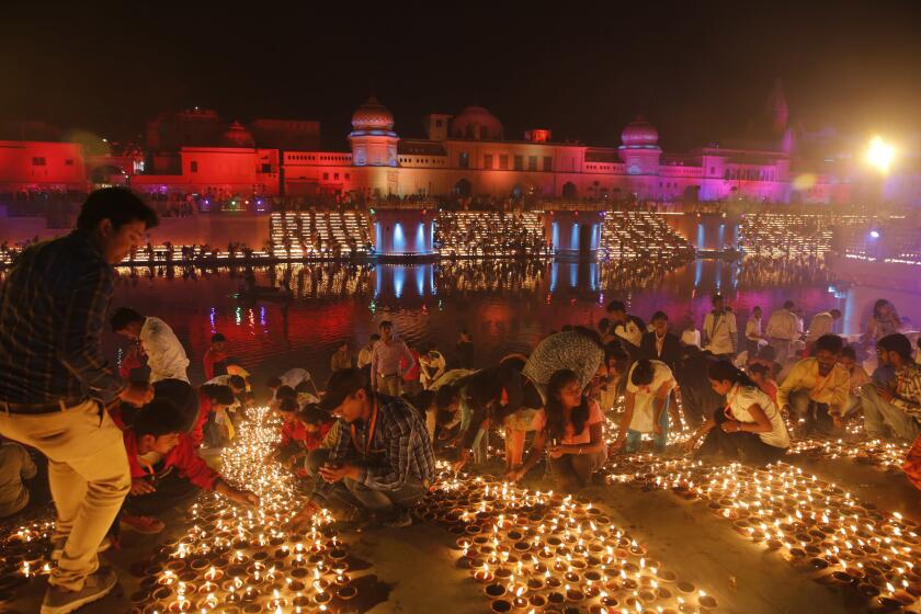 Devotees light earthen lamps on the banks of the River Sarayu as part of Diwali in Ayodhya, India, Tuesday, Nov. 6, 2018. The northern Indian city of Ayodhya has broken a Guinness World Record after lighting 300,150 earthen lamps and keeping them lit for at least 45 minutes.