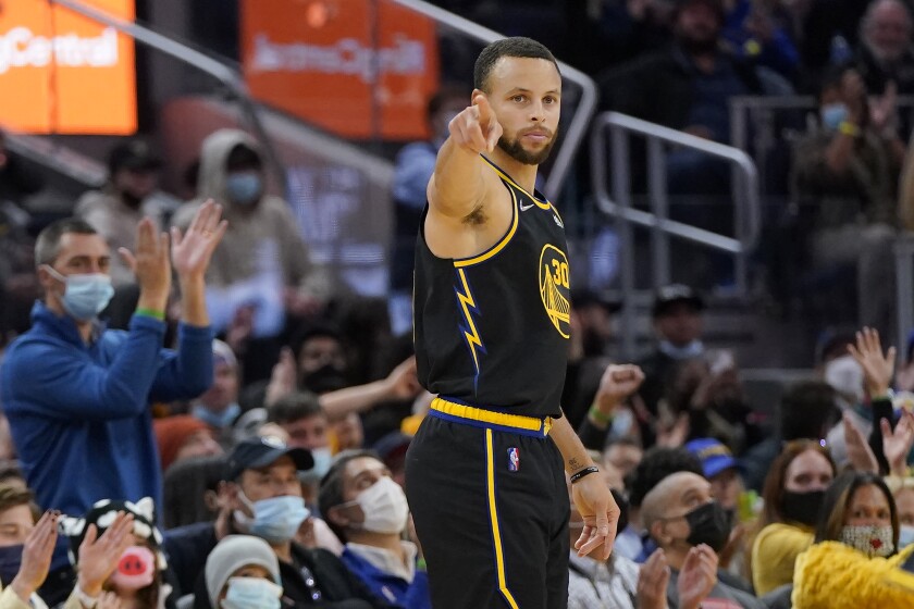 Golden State Warriors guard Stephen Curry gestures after shooting a 3-point basket against the Portland Trail Blazers during the first half of an NBA basketball game in San Francisco, Wednesday, Dec. 8, 2021. (AP Photo/Jeff Chiu)