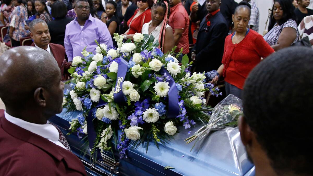 The casket of Terence Crutcher, who was fatally shot by a police officer, is wheeled out of the church following funeral services in Tulsa, Okla., on Saturday.