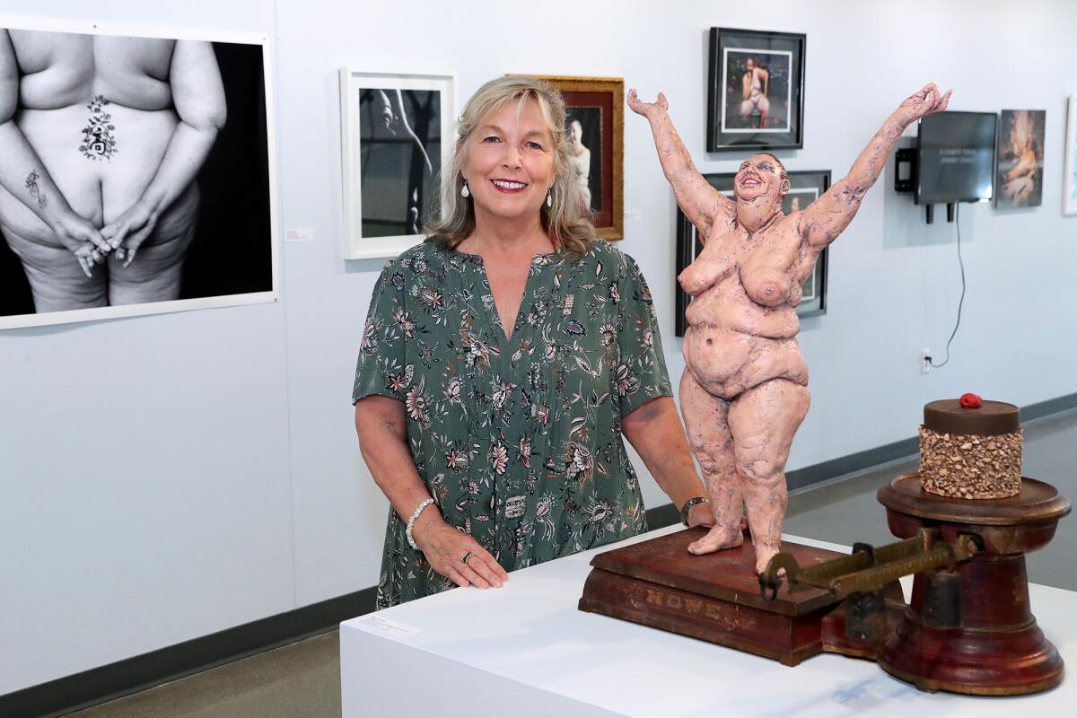 Los Angeles Artist Susan Amorde with her sculpture "Ta-Dah!" at Coastline Art Gallery on Wednesday.